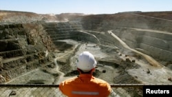 FILE - A miner looks across the largest open pit gold mine in Australia called the Fimiston Open Pit, also known as the Super Pit, in the gold-mining town of Kalgoorlie, located around 500 kilometres east of Perth, July 27, 2001.