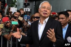 FILE - Malaysia's former Prime Minister Najib Razak speaks to the media after being questioned at the Malaysian Anti-Corruption Commission (MACC) office in Putrajaya, May 24, 2018.