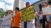 FILE - Faculty and staff at the University of Texas protest against a state law that allows for guns in classrooms at college campuses, in Austin, Texas, U.S. August 24, 2016.