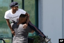 Stevante Clark, the brother of police shooting victim Stephon Clark, is carried away from his brother's wake after confronting members of the media, outside the Bayside of South Sacramento Church in Sacramento, California, March 28, 2018.