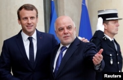 French President Emmanuel Macron welcomes Iraqi Prime Minister Haider Al-Abadi at the Elysee Palace in Paris, Oct. 5, 2017.