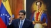 FILE - Venezuela's President Nicolas Maduro holds a copy of the National Constitution while he speaks during a news conference at Miraflores Palace in Caracas, Venezuela, Jan. 9, 2019. 