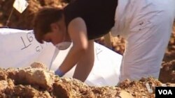 FILE - Forensic experts in Bosnia are digging up hundreds of human remains from one of the largest mass graves found since the country's war ended in 1992.