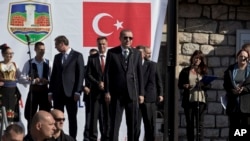 Turkish President Recep Tayyip Erdogan, center, gets ready to deliver a speech in Novi Pazar, some 150 kilometers south of Belgrade, Serbia, Wednesday, Oct. 11, 2017.