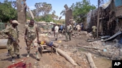 FILE - Security forces attend to the scene following a car bomb attack in Beledweyne, Somalia, Nov. 19, 2013. A new attack killed at least three people, wounded at least 13 others in Beledweyne, Sept. 10, 2017. 