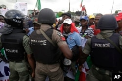 FILE - Protesters face off with policemen following the removal of a fuel subsidy by the government in Lagos, Nigeria, May 18, 2016.