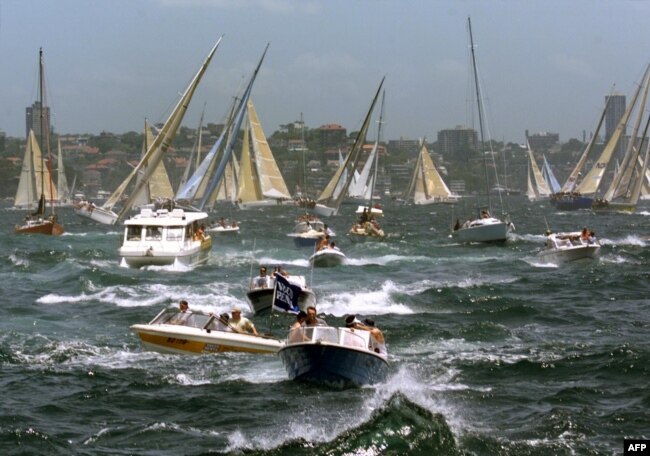 An armada of spectator craft churn up Sydney Harbour during the start of the 54th Sydney-to-Hobart ocean race, Dec. 26, 1998.