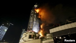 Flames whip through the Address Downtown Dubai hotel in the United Arab Emirates, Dec. 31, 2015. 