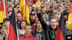 People attend a demonstration in Chemnitz, eastern Germany, Sept.7, 2018, after several nationalist groups called for marches protesting the killing of a German man two weeks ago, allegedly by migrants from Syria and Iraq.