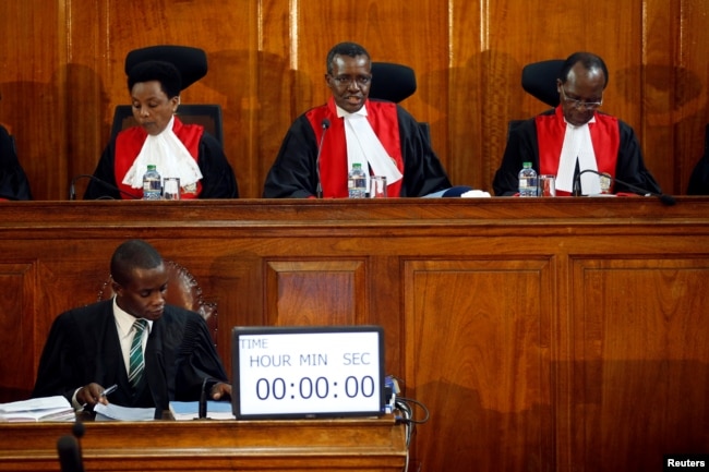 FILE - Kenya's Supreme Court judges attend a hearing regarding petitions challenging the result of the presidential election re-run at Kenya's Supreme Court in Nairobi, Nov. 14, 2017.