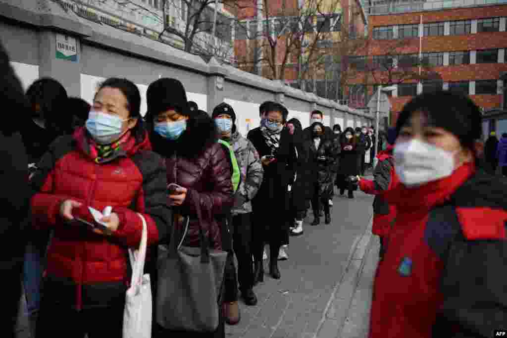 People line up to be tested for COVID-19 during a drive to test two million people in 48 hours, in Beijing.