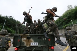 FILE - South Korean army soldiers get off a truck during an anti-terror exercise as part of Ulchi Freedom Guardian in Seoul, South Korea, Aug. 18, 2014.