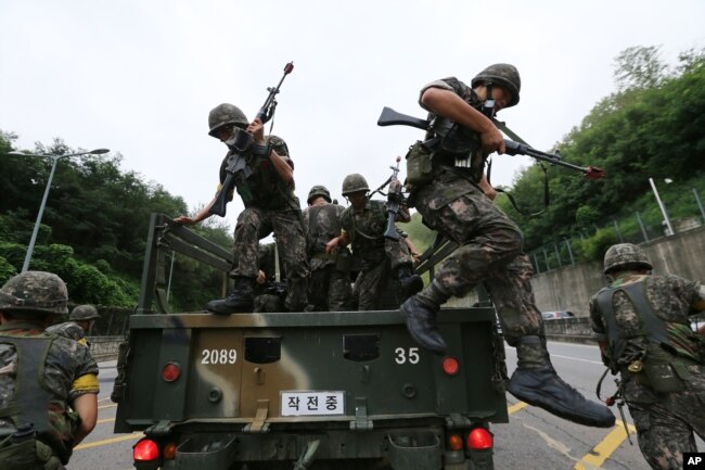 FILE - South Korean army soldiers get off a truck during an anti-terror exercise as part of Ulchi Freedom Guardian in Seoul, South Korea, Aug. 18, 2014.