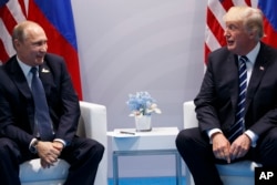 FILE - President Donald Trump meets with Russian President Vladimir Putin at the G20 Summit.