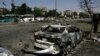 Plusieurs voitures endommagées le long de la route menant à l’aéroport au sud-est de Damas, en Syrie, dimanche 2 juillet 2017. 