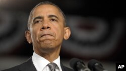 President Barack Obama pauses as he speaks about the Aurora, Colorado shooting at a campaign event in Ft. Myers, Florida, July 20, 2012.