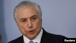 Brazil's President Michel Temer delivers a speech after deputies of the lower chamber of Brazil's Congress voted to reject a corruption charge against him at the Planalto Palace in Brasilia, Brazil, Aug. 2, 2017. 