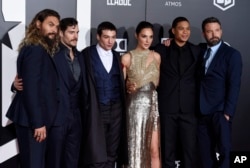 From left, Jason Momoa, Henry Cavill, Ezra Miller, Gal Gadot, Ray Fisher and Ben Affleck, cast members in "Justice League," pose together at the premiere of the film at the Dolby Theatre, Nov. 13, 2017, in Los Angeles.