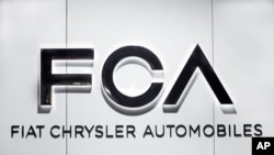  FILE - Fiat Chrysler Automobiles FCA logo is shown at the North American International Auto Show in Detroit, Michigan, Jan. 14, 2019.