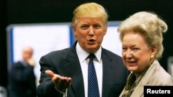 Donald Trump (L) gestures as he stands next to his sister Maryanne Trump Barry.