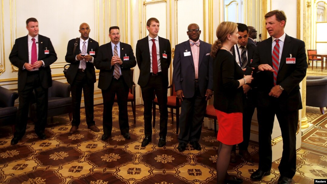 Members of the United States delegation wait outside a room where a meeting between U.S. Secretary of State John Kerry and Iranian Foreign Minister Javad Zarif, is being held at the Palais Coburg hotel in Vienna, Austria, June 28, 2015.