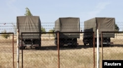 Russian military trucks are seen on the territory of an old military depot near the Russian-Ukrainian border in the town of Boguchar, south of Voronezh, Russia, Sept. 21, 2015.