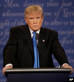 Republican presidential nominee Donald Trump listens to Democratic presidential nominee Hillary Clinton during the presidential debate at Hofstra University in Hempstead, N.Y., Sept. 26, 2016.