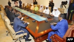 Burkina Faso President Blaire Compaore (R), the top mediator in Mali's crisis, and his delegation meet at the presidential palace in Ouagadougou with rebel leaders (R) from the Islamist Ansar Dine, one of the groups controlling the country's north, June 1