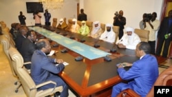 Burkina Faso President Blaire Compaore (R), the top mediator in Mali's crisis, and his delegation meet at the presidential palace in Ouagadougou with rebel leaders (R) from the Islamist Ansar Dine, one of the groups controlling the country's north, June 1