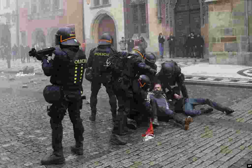 A demonstrator is detained during protest against the COVID-19 restrictive measures at Old Town Square in Prague, Czech Republic.