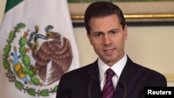 Mexican President Enrique Pena Nieto addresses the media at the Mexican embassy in Paris, France, July 12, 2015. 