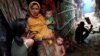 FILE - Rohingya refugees are seen outside their makeshift tent in the Kutupalong camp in Cox's Bazar, Bangladesh, Aug. 24, 2018. 