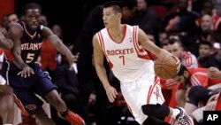 Houston Rockets' Jeremy Lin (7) drives the ball around Atlanta Hawks' DeMarre Carroll (5) in the first quarter of an NBA basketball game on Nov. 27, 2013, in Houston, Texas.