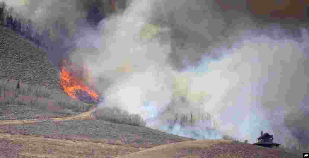 Smoke rises from mountain ridges as a wildfire burns Thursday, Oct. 22, 2020, near Granby, Colo. (AP Photo/David Zalubowski)