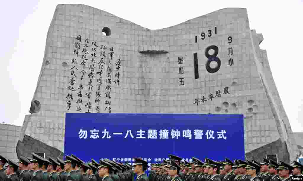 Chinese paramilitary policemen march during a memorial ceremony at the September 18th History Museum in Shenyang, Liaoning province, on the 82nd anniversary of Japan&#39;s invasion of China.