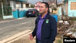 Angel Perez, the mayor of suburban Guaynabo, Puerto Rico, assesses Hurricane Maria's damage in the Vietnam section of Guaynabo, Puerto Rico, Oct. 1, 2017. 