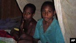 FILE – Mosquito nets helped control malaria after an outbreak in the late 1990s. Today, a mysterious illness initially thought to be malaria has hit Papua, killing at least 41 children within three weeks. 