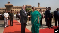 Indian Defense Minister Nirmala Sitharaman, center right, shakes hands with U.S. Defense Secretary Jim Mattis center, upon his arrival at the Defense Ministry office, in New Delhi, India, Tuesday, Sept. 26, 2017.