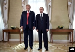 FILE - U.S. President Donald Trump and Russian President Vladimir Putin, right, pose for a photograph at the Presidential Palace in Helsinki, Finland, July 16, 2018 prior to Trump's and Putin's one-on-one meeting in the Finnish capital.