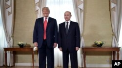 U.S. President Donald Trump and Russian President Vladimir Putin, right, pose for a photograph at the Presidential Palace in Helsinki, Finland, July 16, 2018 prior to Trump's and Putin's one-on-one meeting in the Finnish capital. 