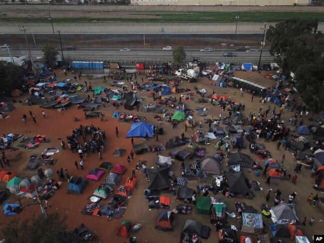 Central American migrants gather at a temporary shelter, near barriers that separate Mexico and the United States, in Tijuana, Mexico, Nov. 21, 2018.
