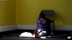 In a photo taken Sept. 23, 2016, a woman prays during a service at the Bernards Township Community Center in in Basking Ridge, New Jersey.