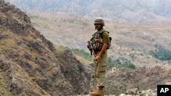 A Pakistan army soldier stands guard in the Pakistani tribal area of Khyber near the Torkham border post between Pakistan and Afghanistan, June 15, 2016.