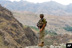 A Pakistan army soldier stands guard in the Pakistani tribal area of Khyber near the Torkham border post between Pakistan and Afghanistan, June 15, 2016.