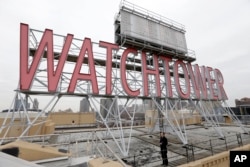 FILE - The iconic Watchtower sign is seen on the roof of 25-30 Columbia Heights, the current world headquarters of the Jehovah's Witnesses, in the Brooklyn borough of New York, Dec. 9, 2015.