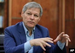 Romanian Premier Dacian Ciolos gestures during an interview with the Associated Press in Bucharest, Romania, Dec. 9, 2016.