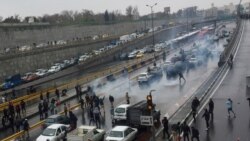 People protest against increased gas price, on a highway in Tehran, Iran