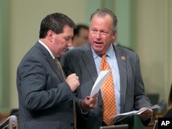 FILE - State Sen. Bill Dodd, D-Napa, right, discusses a measure he has before the Assembly with Assemblyman Tim Grayson, D-Concord, Aug. 31, 2017, in Sacramento, Calif.