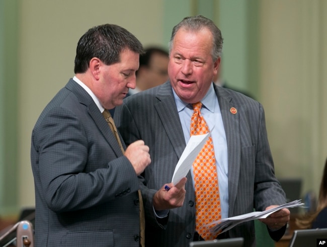 FILE - State Sen. Bill Dodd, D-Napa, right, discusses a measure he has before the Assembly with Assemblyman Tim Grayson, D-Concord, Aug. 31, 2017, in Sacramento, Calif.