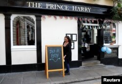 A sign reading "It's a boy" is pictured a day after Meghan, Duchess of Sussex, gave birth to a baby boy, outside the Prince Harry pub in Windsor, Britain May 7, 2019.